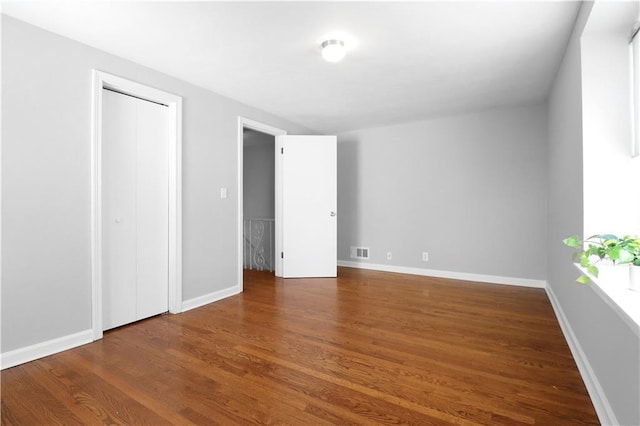 unfurnished bedroom featuring dark wood-type flooring