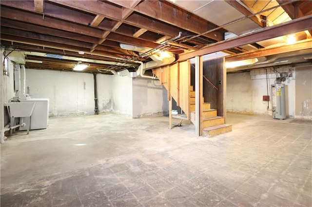 basement with water heater, washer / clothes dryer, and sink