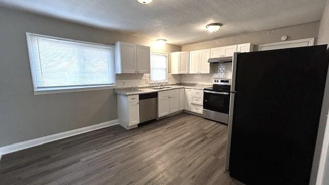 kitchen featuring white cabinets, stainless steel appliances, and dark wood-type flooring