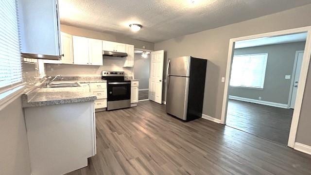 kitchen with a healthy amount of sunlight, white cabinetry, sink, and appliances with stainless steel finishes