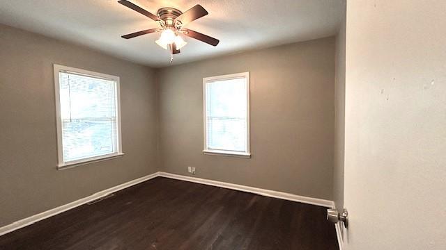 unfurnished room featuring ceiling fan and dark hardwood / wood-style flooring