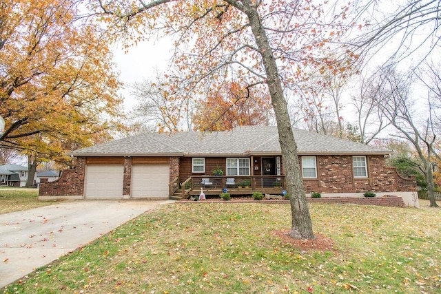 ranch-style house with a front yard, a garage, and a wooden deck