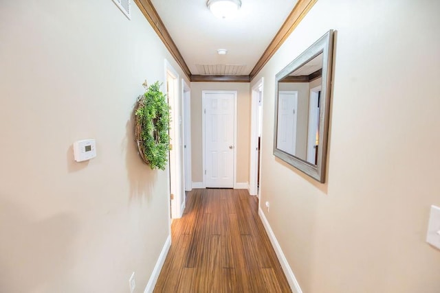 hallway featuring hardwood / wood-style flooring and ornamental molding