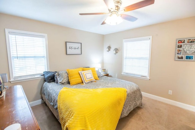 bedroom featuring ceiling fan and carpet