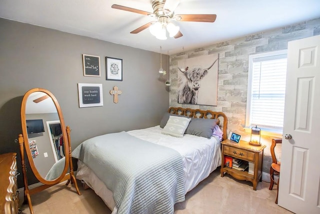 bedroom with light carpet and ceiling fan