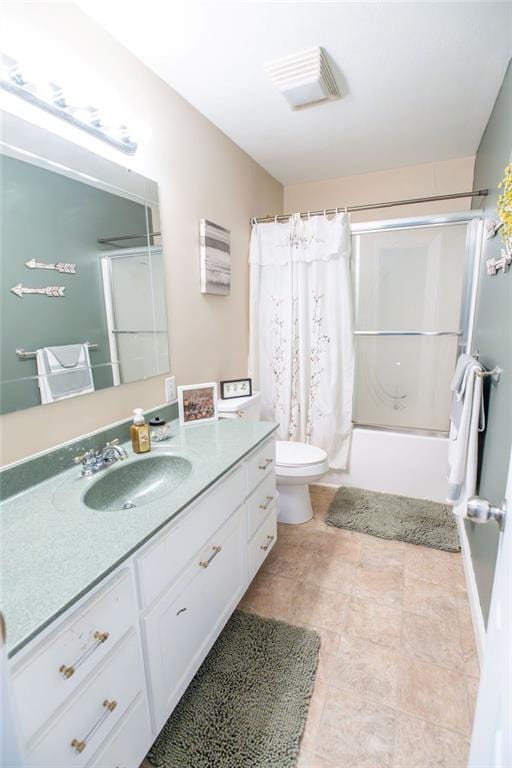 full bathroom featuring shower / bath combo, vanity, and toilet