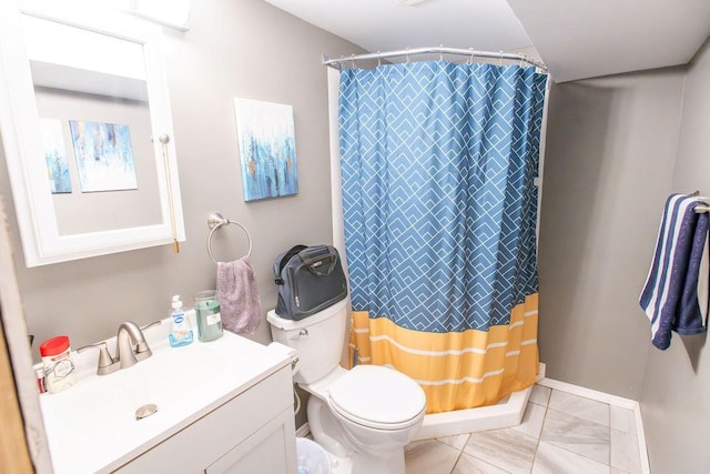 bathroom featuring vanity, toilet, and curtained shower