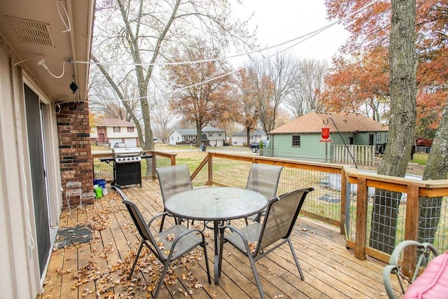 wooden deck featuring a grill