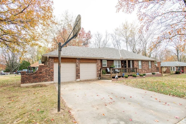 view of front of house featuring a garage and a front lawn