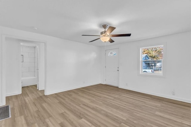 unfurnished room with ceiling fan and light hardwood / wood-style flooring