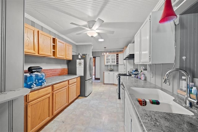 kitchen with ceiling fan, sink, light brown cabinets, appliances with stainless steel finishes, and ornamental molding