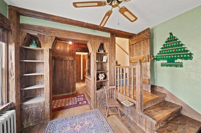 interior space featuring wood-type flooring, radiator, and ceiling fan