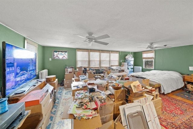 interior space with a textured ceiling and ceiling fan