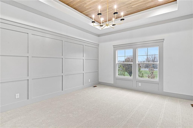 13465 W 174th Pl, Overland Park, KS 66221 - unfurnished room featuring a chandelier, a decorative wall, a raised ceiling, light colored carpet, and wooden ceiling