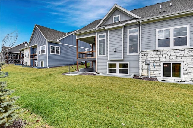 rear view of house featuring a yard