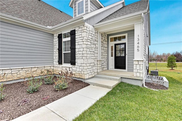 13465 W 174th Pl, Overland Park, KS 66221 - entrance to property featuring stone siding, roof with shingles, and a yard
