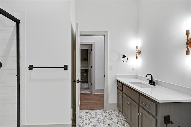 bathroom featuring vanity, a shower with shower door, and wood-type flooring