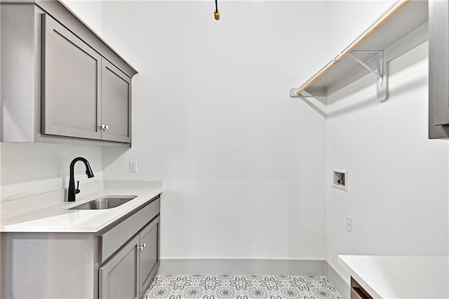 laundry area featuring hookup for a washing machine, sink, and cabinets