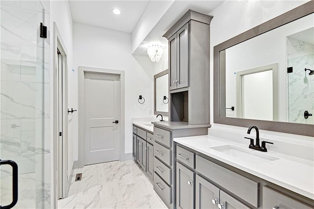 bathroom featuring a shower with door and vanity