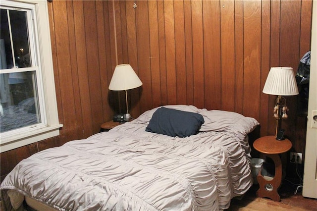 bedroom with wooden walls