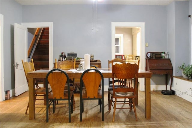 dining space with light hardwood / wood-style flooring