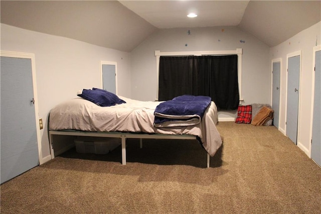 carpeted bedroom with vaulted ceiling