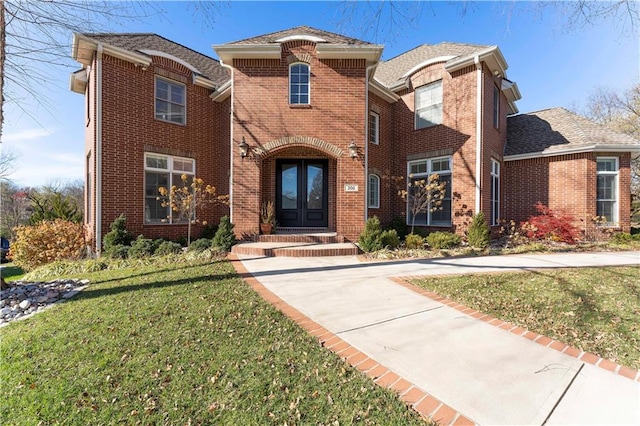 view of front of house with a front lawn and french doors