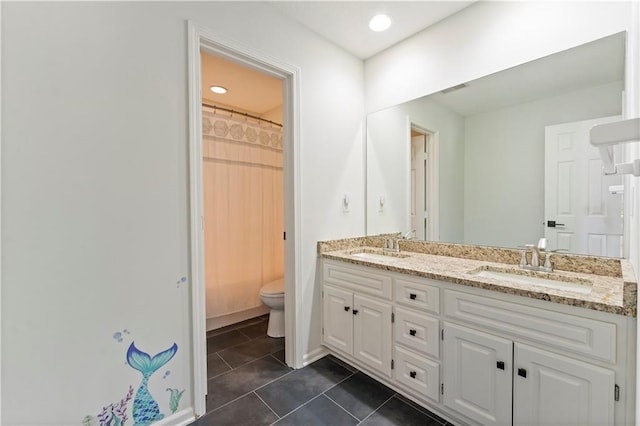 bathroom with tile patterned floors, vanity, toilet, and walk in shower