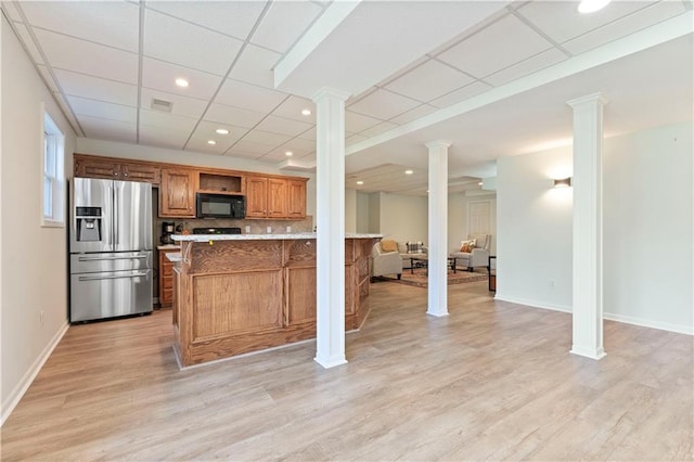 kitchen featuring tasteful backsplash, stainless steel fridge with ice dispenser, a drop ceiling, and light hardwood / wood-style floors