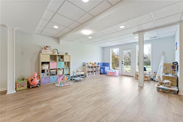 playroom featuring a paneled ceiling, light hardwood / wood-style flooring, and french doors