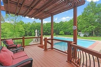 wooden terrace with an outdoor living space and a pergola