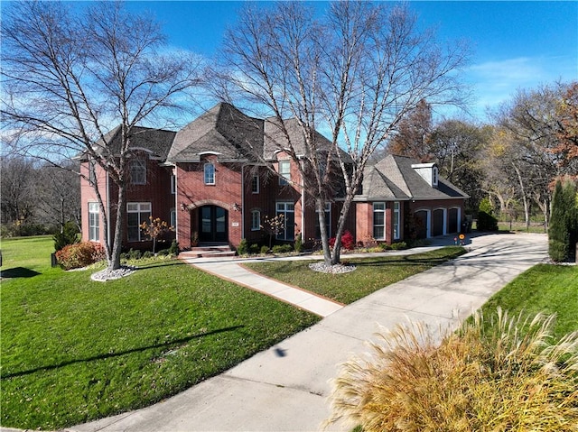 view of front of house with a front yard and a garage