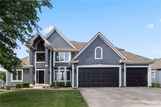 view of front of home featuring a garage and a front yard