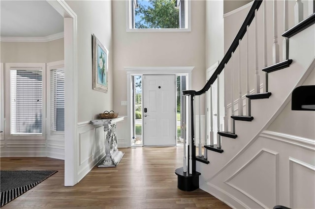 entrance foyer featuring hardwood / wood-style flooring and crown molding