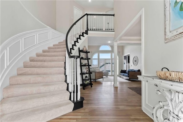 entryway with ornate columns and hardwood / wood-style flooring