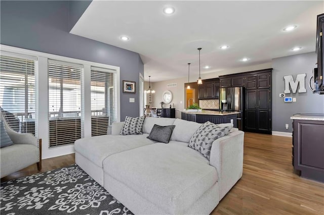 living room with a chandelier and dark wood-type flooring