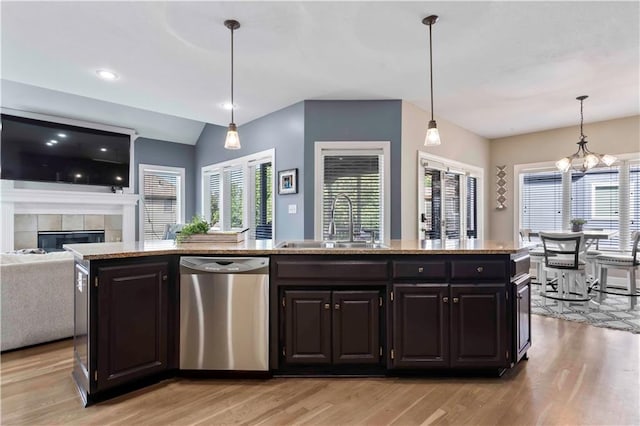 kitchen with decorative light fixtures, stainless steel dishwasher, a healthy amount of sunlight, and sink