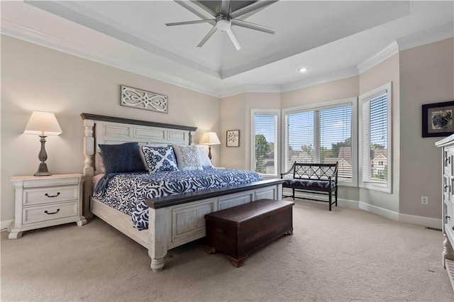 bedroom with a tray ceiling, ceiling fan, crown molding, and light colored carpet