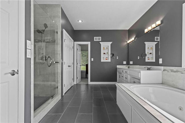 bathroom featuring tile patterned flooring, vanity, and shower with separate bathtub