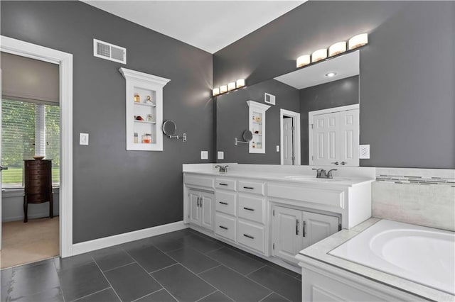 bathroom featuring tile patterned floors, vanity, and a bathtub