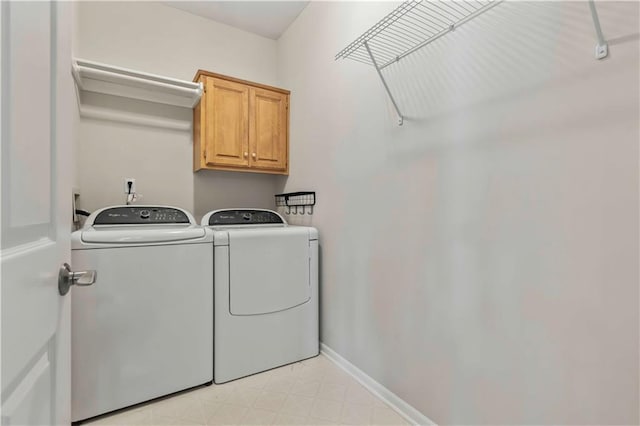 washroom with cabinets and separate washer and dryer