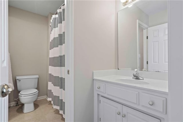 bathroom with tile patterned floors, curtained shower, vanity, and toilet