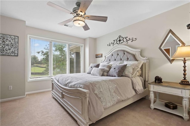 bedroom with ceiling fan and light colored carpet