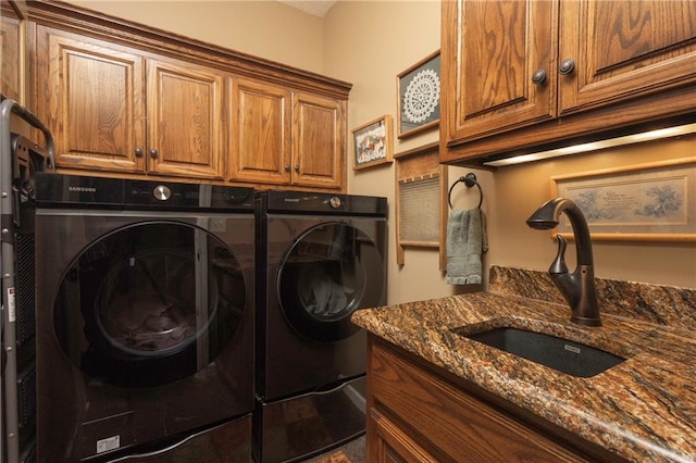 laundry room with sink, separate washer and dryer, and cabinets