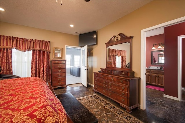 bedroom with sink, a textured ceiling, and ensuite bathroom