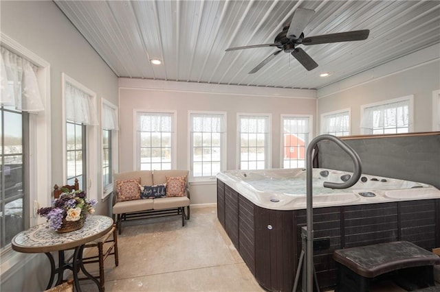 sunroom featuring ceiling fan and a jacuzzi