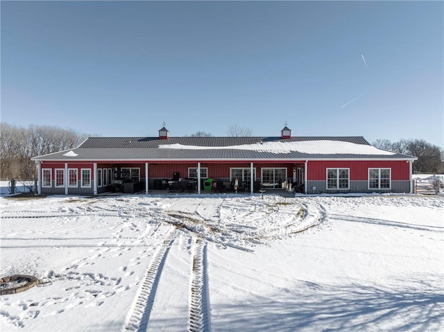 view of snow covered back of property