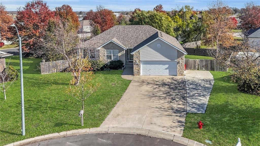 view of front of property with a front yard and a garage