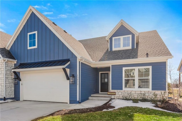 view of front of home featuring a garage, stone siding, board and batten siding, and roof with shingles