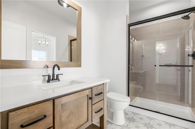 bathroom with a shower stall, toilet, and vanity